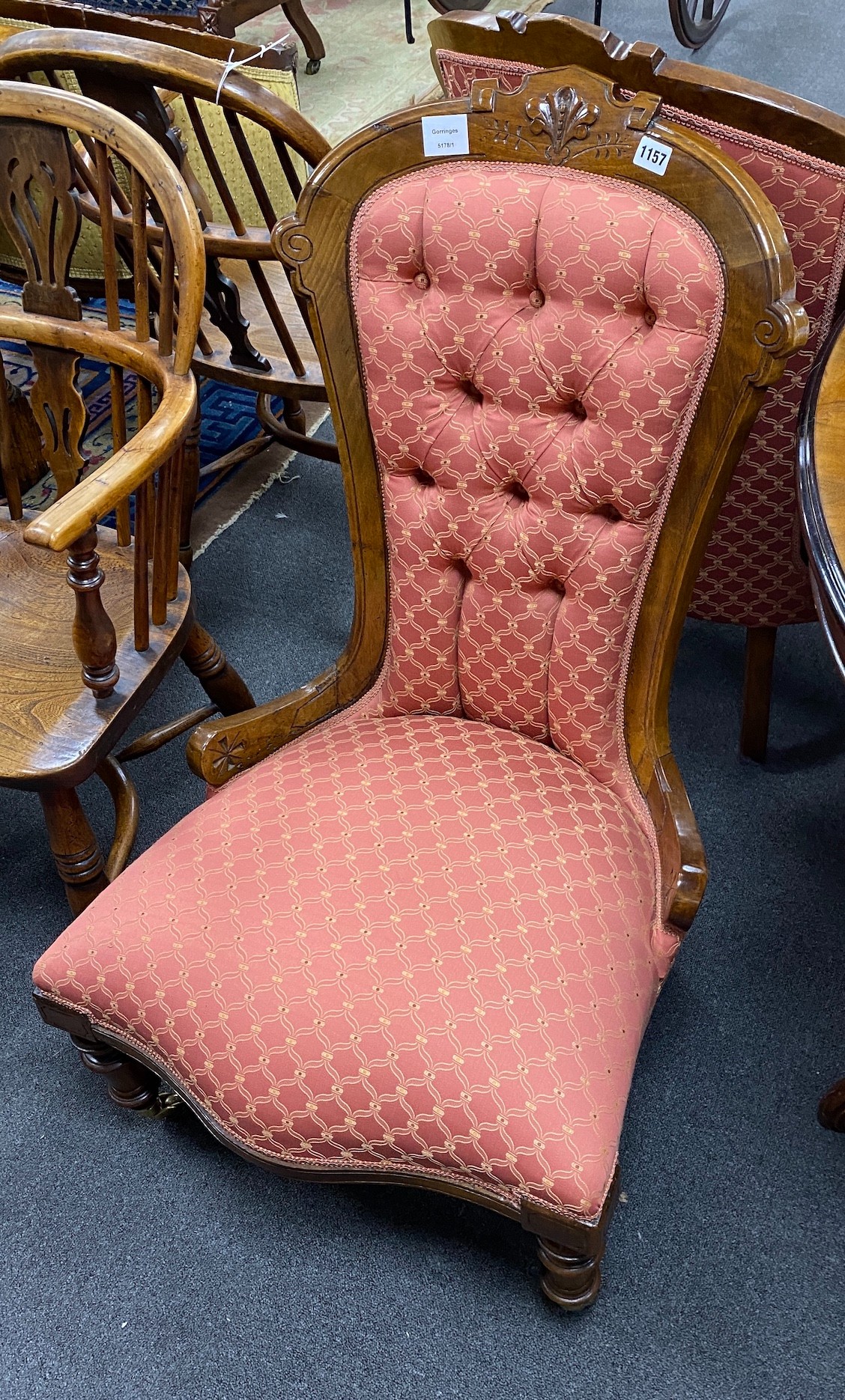 A pair of late Victorian walnut spoon back upholstered chairs, one with arms